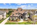 Stunning exterior elevation featuring brick, stone, turret, and mature landscaping at 1311 Sunnys Halo Ln, Waxhaw, NC 28173