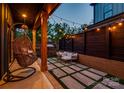 Stylish backyard patio area with hanging swing chair, comfortable seating, and string lights at 1505 Landis Ave, Charlotte, NC 28205