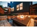 Backyard entertaining space with modern fire pit, outdoor seating, and lush landscaping at 1505 Landis Ave, Charlotte, NC 28205