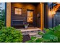 Inviting front porch with a cozy bench, charming plants, and a welcoming entryway at 1505 Landis Ave, Charlotte, NC 28205