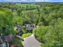 A stunning aerial view of the home situated on a vast, private lot surrounded by lush greenery and mature trees at 15101 Sharrow Bay Ct # 12, Huntersville, NC 28078