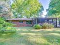 Lush backyard features a screen porch and well-maintained lawn, perfect for outdoor activities at 1881 Sharonwood Ln, Rock Hill, SC 29732