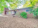 Quaint single story brick home with mature trees adding shade and character to the property at 1881 Sharonwood Ln, Rock Hill, SC 29732
