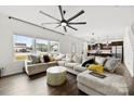 Bright living room with large sectional, modern ceiling fan, and views to the kitchen at 1976 Ethan Ln, Stanfield, NC 28163