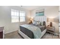 Cozy bedroom featuring neutral tones, a plush bed, and a bright window at 2624 Tillman St, Monroe, NC 28112