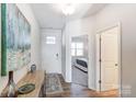 Inviting entryway with wood flooring, complemented by a stylish console table and view to the bedroom at 2624 Tillman St, Monroe, NC 28112