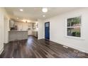 An open floor plan boasts stylish flooring and leads into a kitchen with a peninsula and stainless appliances at 2741 Cowles Rd, Charlotte, NC 28208
