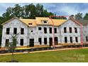 New construction home featuring a multi-level design, visible framing, and a partially installed roof at 280 Gilead Rd, Huntersville, NC 28078