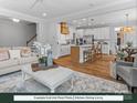Open-concept living space with modern kitchen, island seating, and inviting living room with ample natural light at 280 Gilead Rd, Huntersville, NC 28078