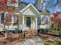 Inviting front entrance with detailed trim work, a cozy porch, and landscaped garden beds at 3005 Somerset Dr, Charlotte, NC 28209