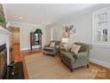 Cozy living room with hardwood floors, a fireplace, and comfortable seating area at 3005 Somerset Dr, Charlotte, NC 28209