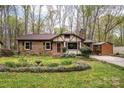 Quaint home with a well-maintained lawn, chimney, and covered deck at 313 E Church St, Stanley, NC 28164