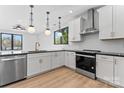 Bright kitchen features white cabinets, stainless steel appliances, and contrasting black countertops at 3433 Byrnes St, Charlotte, NC 28205