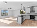Open concept kitchen with modern lighting, stainless steel appliances, and black countertops at 3433 Byrnes St, Charlotte, NC 28205