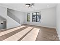 Bright open living room with contemporary staircase, modern lighting, and natural light at 3433 Byrnes St, Charlotte, NC 28205