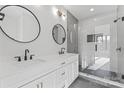 Modern bathroom featuring dual sinks, matte black fixtures, and a large glass-enclosed shower with tile surround at 3437 Byrnes St, Charlotte, NC 28205