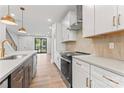Modern kitchen with stainless steel appliances, gray countertops, and stylish pendant lighting at 3441 Byrnes St, Charlotte, NC 28205