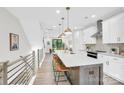 Bright, modern kitchen with stainless steel appliances, large island, and pendant lighting at 3441 Byrnes St, Charlotte, NC 28205