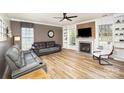 Cozy living room with a fireplace, hardwood floors, and comfortable seating creating a relaxing atmosphere at 4001 Brook Valley Run, Monroe, NC 28110