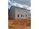 Picture of the back of a home with large windows and a door leading to the backyard, all set on a spacious lot at 436 Phifer Rd, Kings Mountain, NC 28086