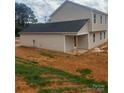 The back of the home features a covered porch and second-story windows overlooking a large, grassy backyard at 438 Phifer Rd, Kings Mountain, NC 28086