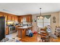 Eat-in kitchen featuring oak cabinets, laminate countertop, stainless steel appliances, and a dining area at 4896 Birch Cir, Hickory, NC 28602