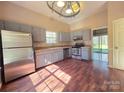 Updated kitchen with stainless steel appliances, gray cabinets, and lots of natural light at 5416 River Falls Dr, Charlotte, NC 28215