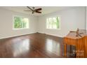 Bright living room with gleaming hardwood floors, and a classic ceiling fan at 5601 Indian Brook Dr, Matthews, NC 28104