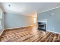 A spacious living room is enhanced with the fireplace and the warm tones of the hardwood floor at 5913 Crape Myrtle Ln, Charlotte, NC 28216