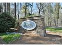 Stone monument sign for the Woodrun subdivision surrounded by lush landscaping at 623 Roxboro Dr, Mount Gilead, NC 27306