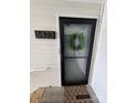 Close up of the unit's front door with decorative wreath and door number at 6423 Town Hall Pl, Harrisburg, NC 28075