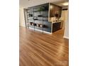 Open-concept floor plan with stylish shelving and durable wood-look flooring at 6423 Town Hall Pl, Harrisburg, NC 28075
