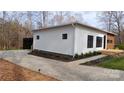 Modern home featuring white horizontal siding, black trim, and a concrete driveway at 6548 Emerald Isle Dr, Sherrills Ford, NC 28673