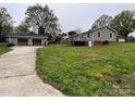 Exterior view of the home with detached garage and well-maintained lawn at 8124 Wood St, Mount Pleasant, NC 28124