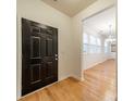 Inviting entryway featuring hardwood floors and a black front door, with a view into the living area at 9001 Lanark Ln, Indian Land, SC 29707