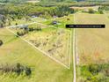 Breathtaking aerial view of a 7-acre lot featuring sprawling acreage and idyllic surroundings at 909 Old Mocksville Rd, Statesville, NC 28625
