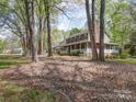 Lovely home with a spacious front porch and beautiful, mature trees surrounding the property at 940 Brittany Ct # 23, Gastonia, NC 28056