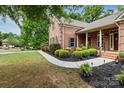 Well-maintained home with manicured landscaping, a brick exterior, and a covered front porch at 9506 Minnie Lemmond Ln # 170, Mint Hill, NC 28227