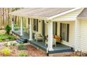 Relaxing front porch with rocking chairs, comfortable seating, and stylish decor at 9820 Janeiro Dr, Huntersville, NC 28078