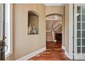 Inviting foyer with hardwood floors, staircase, and decorative niche creating a warm entry at 11308 Wheat Ridge Rd, Charlotte, NC 28277