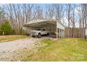 Carport with a truck and a boat parked on a gravel surface at 1197 Fincher Rd, Fort Lawn, SC 29714