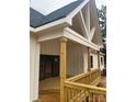 Inviting exterior with wooden porch, white siding, and distinctive architectural detail at 1204 Sage Pine Cir, Clover, SC 29710