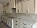 Bright kitchen features elegant cabinetry, modern hardware, and stylish backsplash at 1204 Sage Pine Cir, Clover, SC 29710