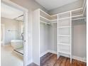 A main bedroom closet and adjoining bathroom with a glass shower at 1204 Sage Pine Cir, York, SC 29710