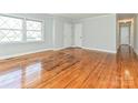 Bright living room with gleaming hardwood floors, large windows, and neutral paint providing a cozy atmosphere at 12300 Eva St, Matthews, NC 28105