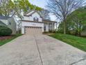 Charming two-story home with a beige garage door and a welcoming front porch at 12708 Hollyhock Ln, Huntersville, NC 28078