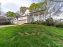 Traditional home with a beige garage door and a welcoming front porch, set on a lush lawn at 12708 Hollyhock Ln, Huntersville, NC 28078