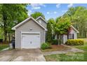Exterior view of a charming home with a well-manicured lawn, landscaping, and an attached garage at 12804 Lismorre Castle Ct, Charlotte, NC 28273