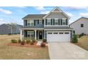 Charming two-story home with a manicured lawn and a two-car garage at 1409 Augustus Beamon Dr, Indian Trail, NC 28079