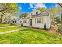 Inviting home boasting a lush lawn, and mature trees that create a warm, welcoming atmosphere at 1409 Effingham Rd, Charlotte, NC 28208
